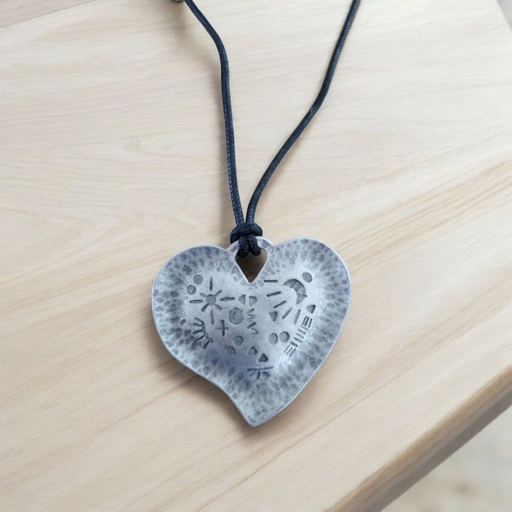 Vintage Pewter Heart Pendant with Caved Symbols on a Black Cord